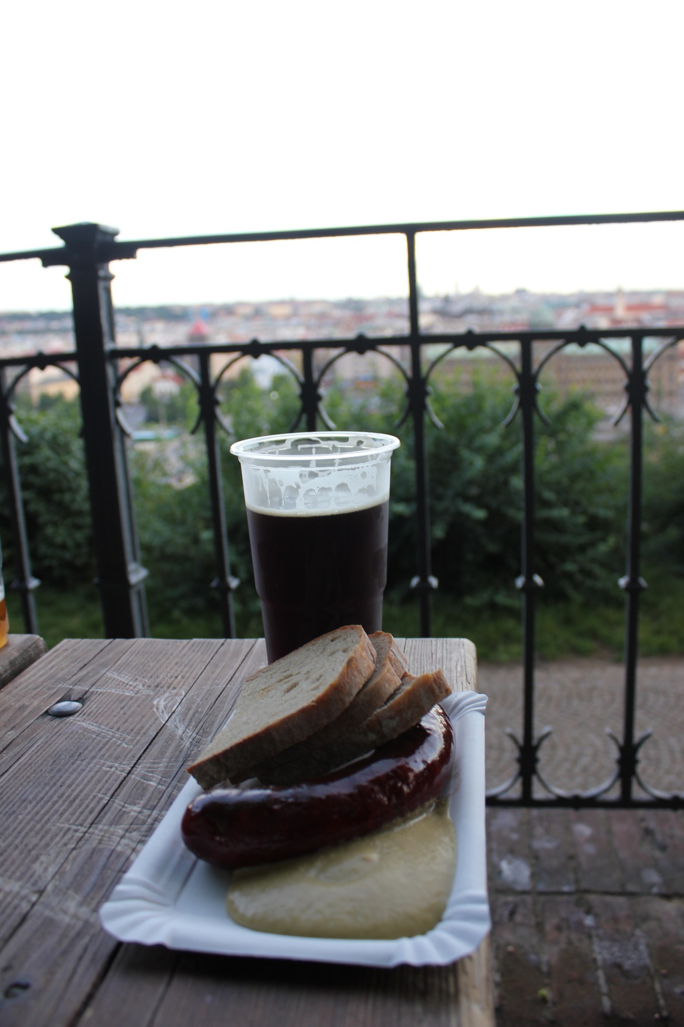 Sausage, rye bread, mustard, and stout at the Letna beer garden in Prague