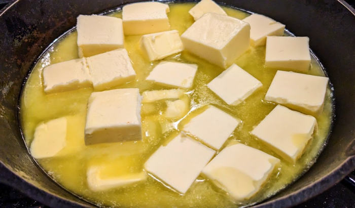 Butter in a cast iron pan, the first step in making ghee or clarified butter